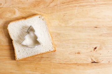 white bread sliced, cut to christmas tree shape. top view.