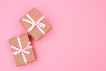 Christmas or New Year gift box on a pink background with copy space