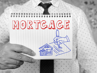 MORTGAGE phrase on the sheet. Buying Home with Mortgage and Paying Credit to Bank