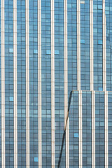 A beautiful background of an glass office building, reflecting clouds in the opened windows