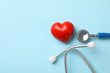 Blue stethoscope and heart on blue background