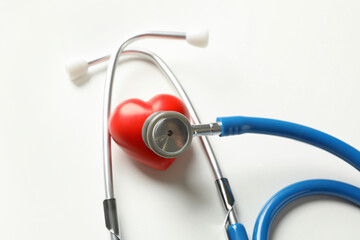 Blue stethoscope and heart on white background
