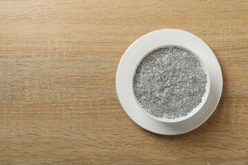 Bowl with chia pudding on wooden background