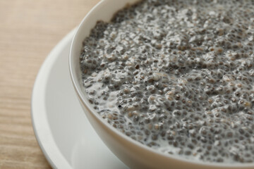 Bowl with chia pudding on wooden background