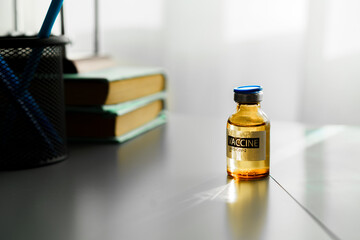 Sars-cov-2 vaccine glass bottle on table close up