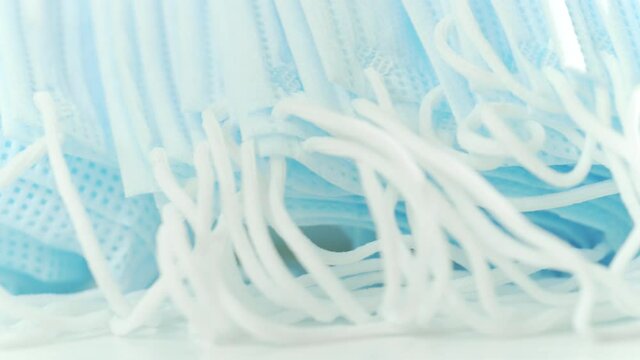 Macro dolly shot of a pile of blue medical face masks
