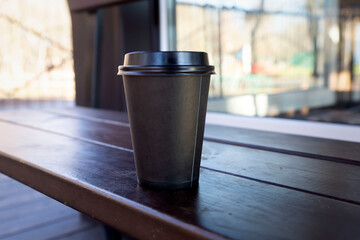 Coffee in disposable glasses on a dark background.