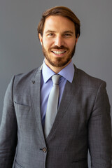 Handsome smiling confident businessman portrait in office