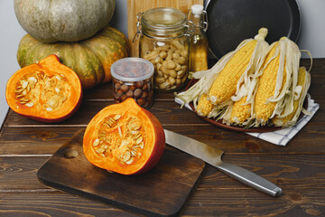 Pumpkin cut into halves on dark wooden table