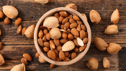 almond on wood background- top view