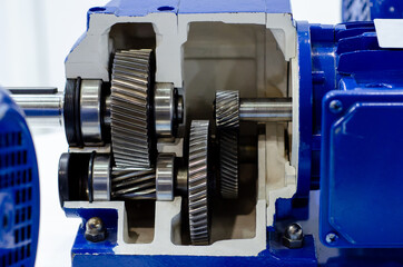 Close-up of cross-section helical gearbox with motor