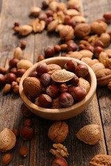 almond on wood background- top view