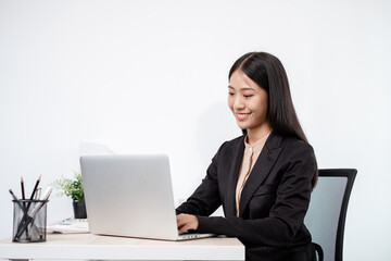 Asian businesswomen sit at their desks and calculate financial graphs showing results about their...
