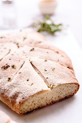 Homemade fresh baked Fougasse (French Bread) with thyme and olive oil on white background. Traditional Provencal dishes. Selective focus
