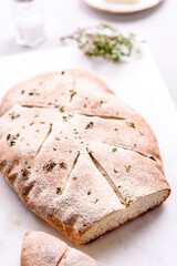 Homemade fresh baked Fougasse (French Bread) with thyme and olive oil on white background. Traditional Provencal dishes. Selective focus