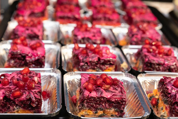 traditional Russian puff salad for the new year, the name is herring under a fur coat, an appetizer with mayonnaise, decorated with parsley and pomegranate seeds