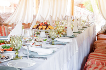 Table decorations for holidays and wedding dinner. Table set for holiday, event, party or wedding reception in outdoor restaurant.