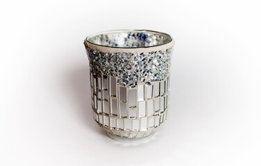 Glass glass covered with pieces of mirror closeup on a white background