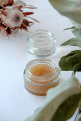 Obraz na płótnie Canvas Two jars with cosmetics on a light background. Scrub and moisturizing gel for skin care