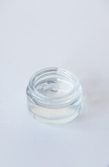 Jar with cosmetic moisturizing gel for face or body on light background