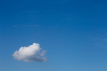 white cloud with a blue sky as a background, with space to put text. copy space