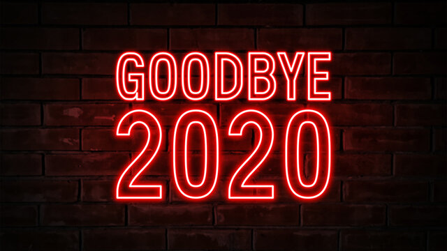 Goodbye 2020 - red neon light word on brick wall background