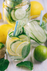 Detox refreshing sassy water with cucumber, ginger, mint and lemon in glasses, Healthy eating concept. Light background. Close-up. Body detoxication.