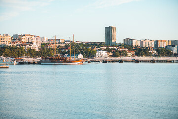 Obraz premium Gelendzhik, Russia, 27 May 2020: Resort city and central pier with standing pleasure ships and yachts in Black sea bay in summer day.