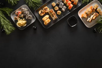 Foto op Plexiglas Festive Christmas asian food with sushi set, holiday decoration on black background. View from above. Flat lay style. New Year party. © svetlana_cherruty