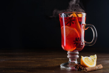 Glass of hot steamed mulled wine on table 