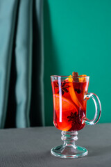 Glass of mulled wine on green