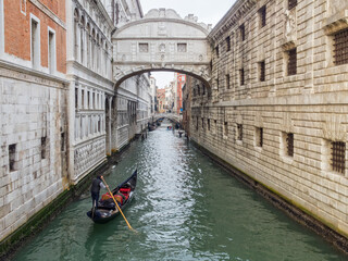 A gondola approaches the Bridge of Sighs on the Rio del Palazzo - Venice, Veneto, Italy