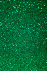 Green color blured sparkling background with focused area.