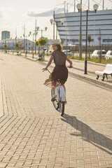 woman biking away