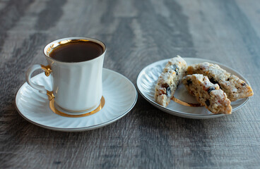 Christmas homemade cookies biscotti with dry berries and cup of coffee. Copy space.