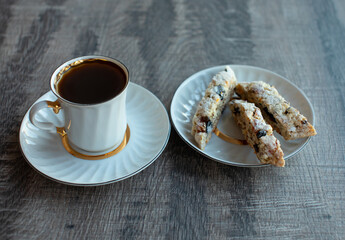 Christmas homemade cookies biscotti with dry berries and cup of coffee. Copy space.