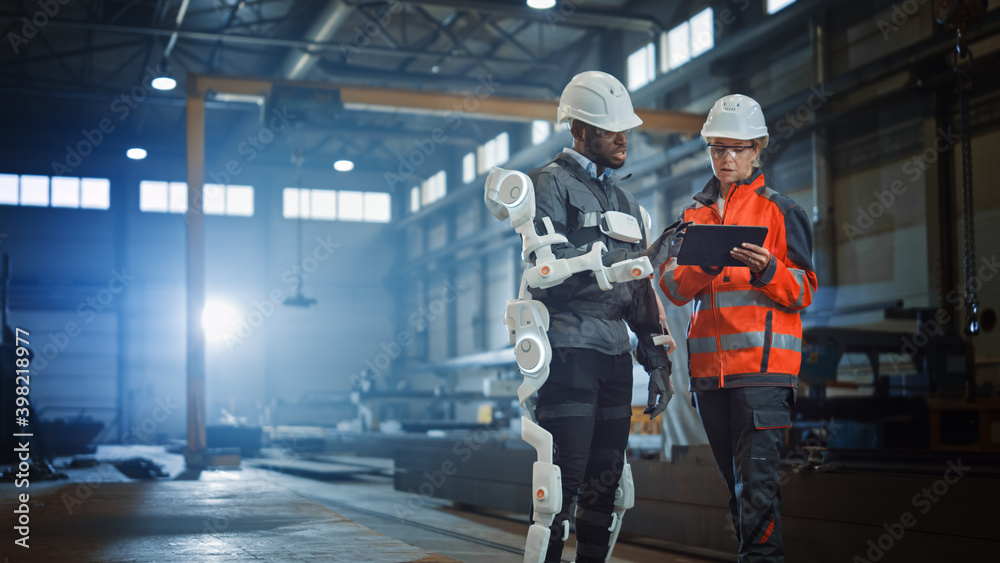 Leinwandbilder futuristic concept of a manual labor worker in a bionic exoskeleton prototype working in a factory. 