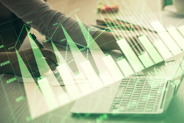 Double exposure of businesswoman hands typing on computer and forex chart hologram drawing. Financial analysis concept.