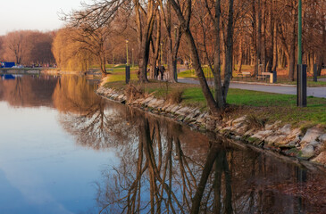 beautiful cityscape autumn park golden trees and blue lake