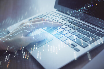 Double exposure of woman hands typing on computer and forex chart hologram drawing. Stock market analysis concept.