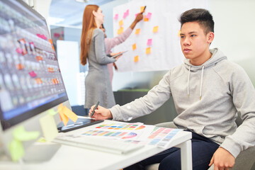 Asian man as a programmer on the PC