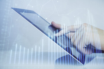 Multi exposure of man's hands holding and using a digital phone and forex graph drawing. Financial market concept.