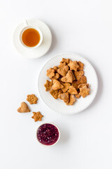 Chocolate cookies flat lay with berry jam and tea