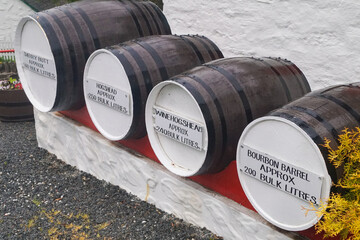 Four different sized whisky barrels for maturation. They have a description on them with the name...
