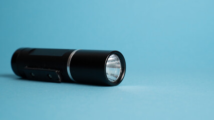 Bicycle lights on blue background. Rechargeable hand lamp. LED torch. Flashlight led torch light