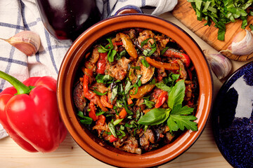Ajapsandal.  Traditional Georgian appetizer cooked from aubergine, pepper, onion, carrot, tomato, garlic, basil, parsley and different sorts of herbs and spices in а clay blue casserole dish.