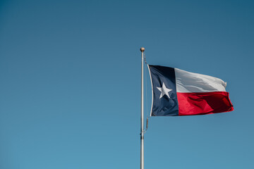Texas state flag on blue sky