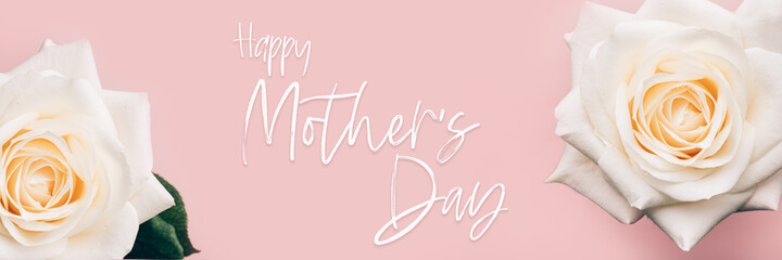 Happy Mothers Day text. Close up of beautiful big white rose on light pink background, top view, banner size,