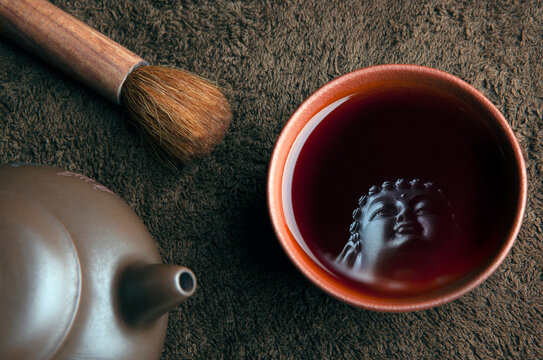 image of teapot cup brush buddha reflection 