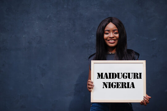 African woman hold white board with Maiduguri Nigeria inscription. Most populous city in Africa concept.